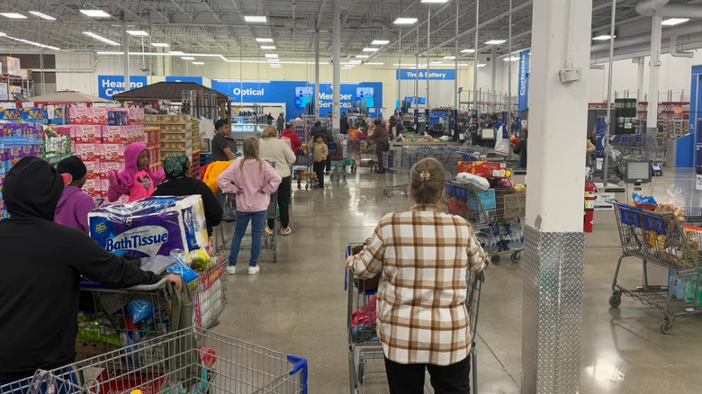 Impatient customers wait in line to be checked out at a Sam's Club