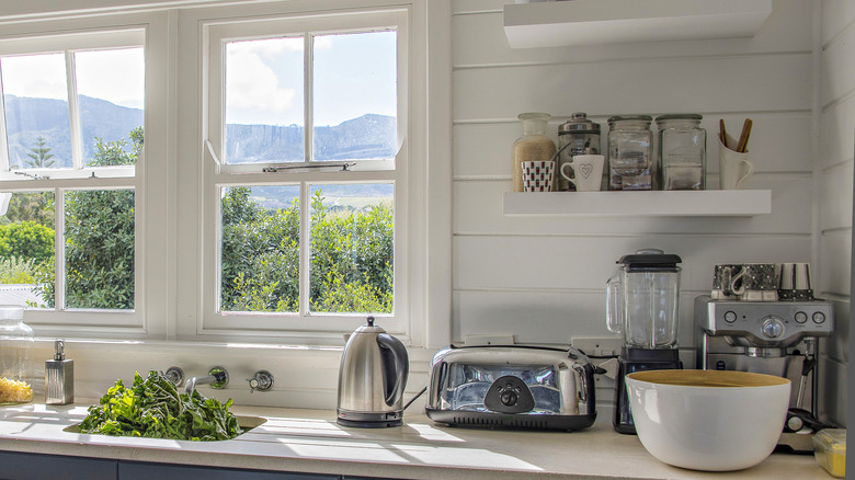Cluttered kitchen countertop with several appliances