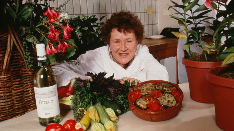 Chef Julia Child smiling with some food