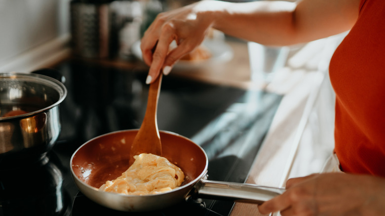 Stirring eggs in a pan