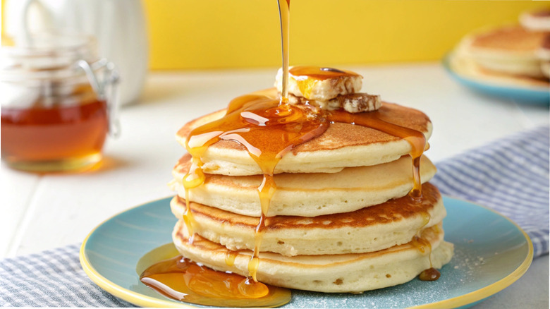 Pancakes on a plate with syrup and butter