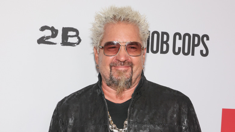 Guy Fieri smiling in sunglasses