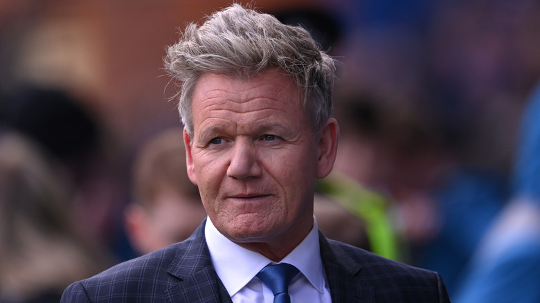 Celebrity chef Gordon Ramsay wearing a blue tie and dark plaid jacket