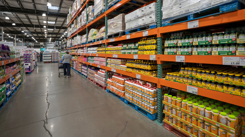 A person nears the end of an aisle in a Costco store