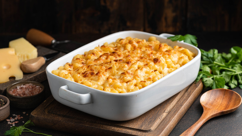 A white crock of baked mac and cheese.