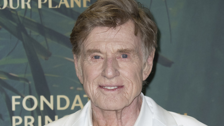 Robert Redford smiling in white