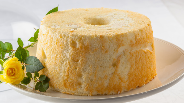 Angel food cake next to a yellow flower