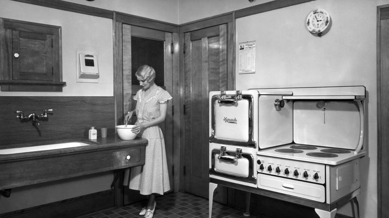 Woman cooking in a 1920s kitchen