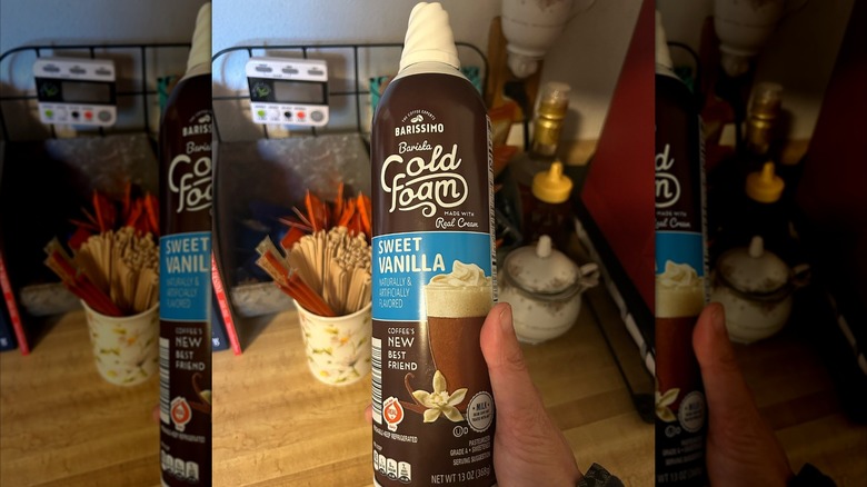 Hand holding can of Barissimo Barista Cold Foam from Aldi