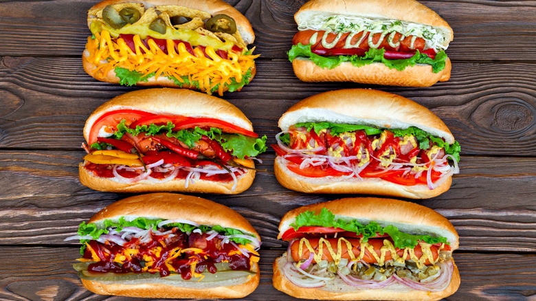Various hot dogs in buns with different toppings