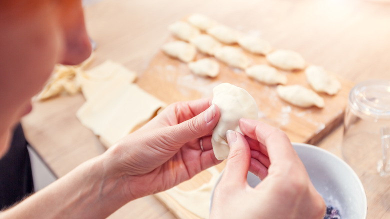 Woman making pierogies