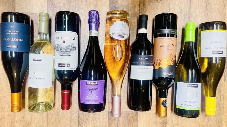 Various Kirkland Signature wines lined up on wooden background