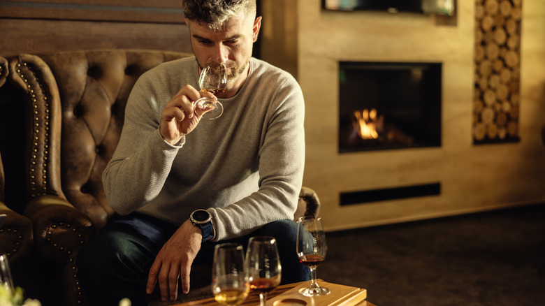 Person sampling whiskeys