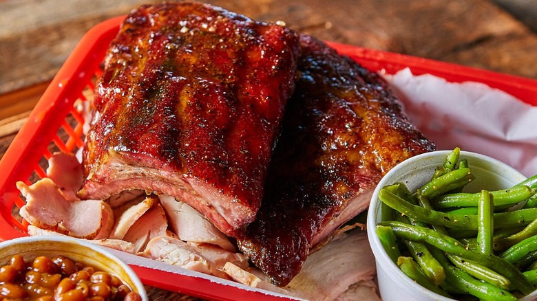 Ribs on a barbecue tray with sides