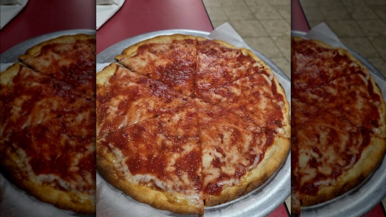 A big thin crust pizza pie smothered in sauce from Tommy's Pizza