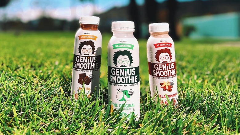 bottles of genius juice coconut smoothies on grass