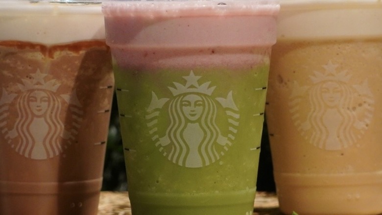 Close-up view of Starbucks' Salted Caramel Mocha Strato Frappuccino, Strawberry Matcha Strato Frappuccino, and Brown Sugar Strato Frappuccino