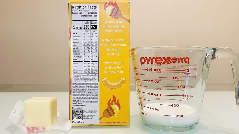 Back of Kraft Hot Honey Mac & Cheese box with butter and measuring glass of milk