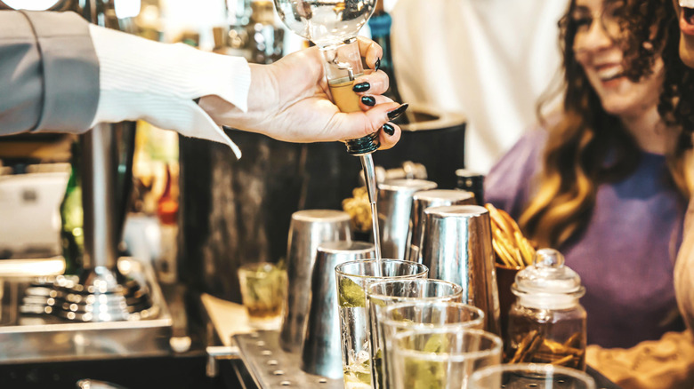 Bartender using a speed pour spout to make mojitos