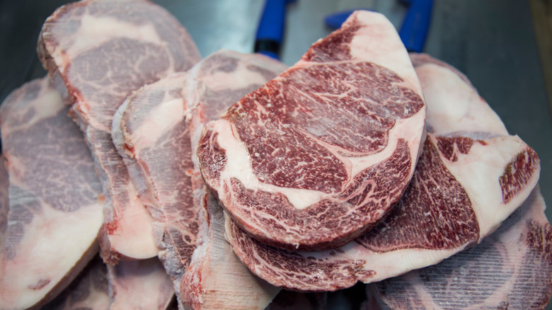 A pile of frozen steaks