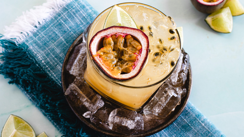 overhead of passion fruit caipirinha on ice with napkin