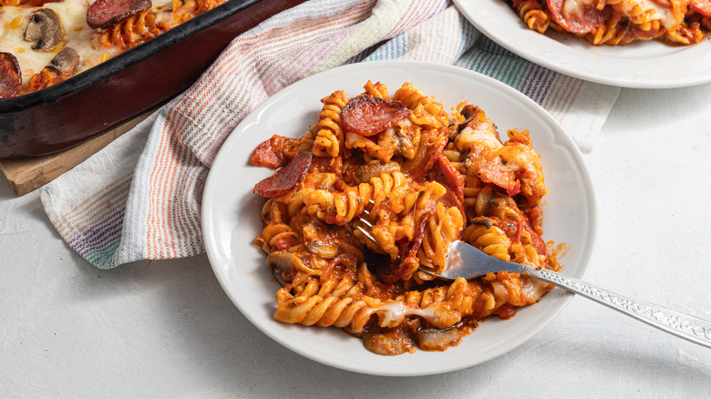 fork with plate of pepperoni pasta bake