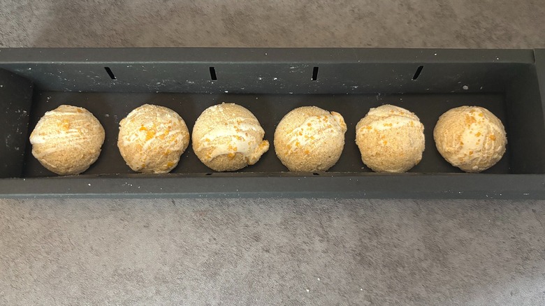 Open box of Milk Bar Cereal Milk Iced Latte Bombs on black surface