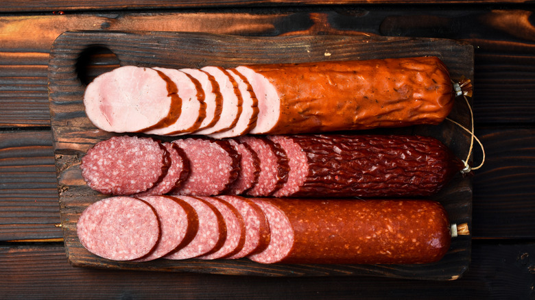 Three types of salami served on cutting board