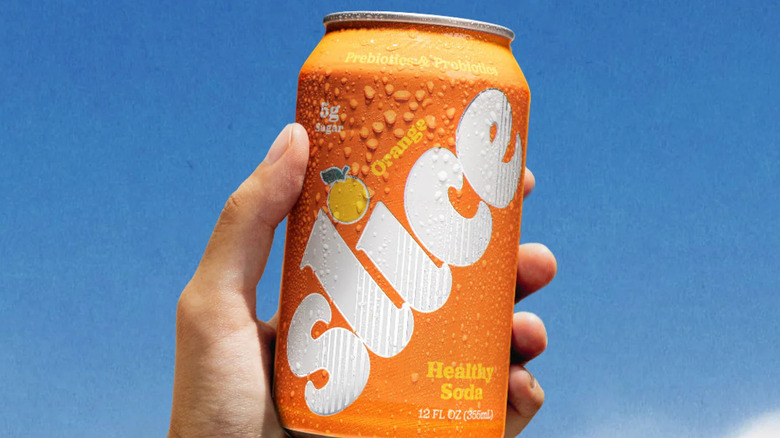 A can of Orange Slice in a hand
