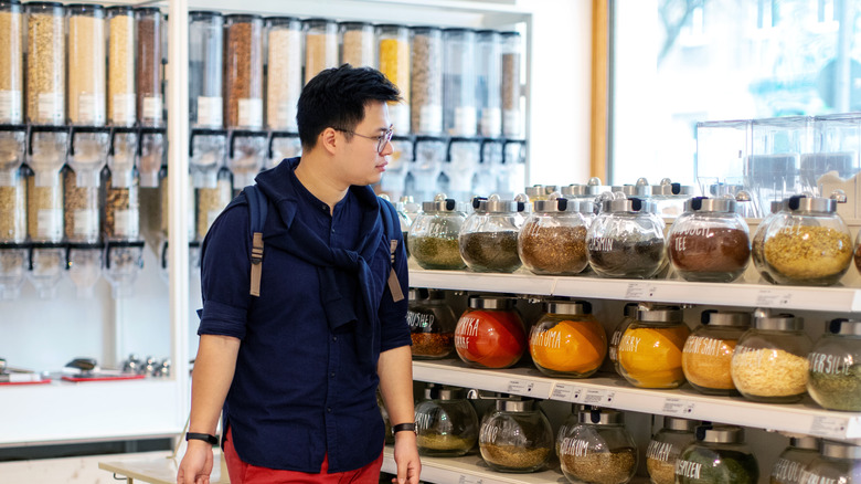 Man looking at bulk spices