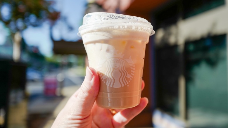 Apple crisp-flavored Starbucks beverage held in hand