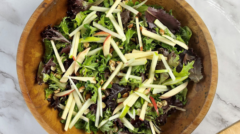Salad with apple slices in bowl