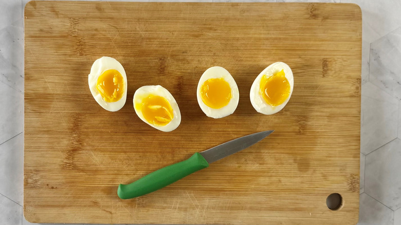 foud egg halves on wooden board