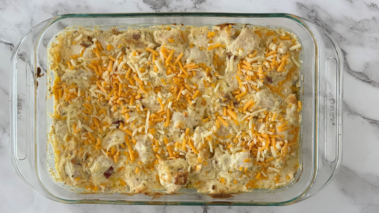 creamy chicken casserole with shredded cheese on top