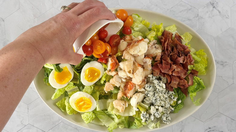 topping lettuce with cobb salad ingredients