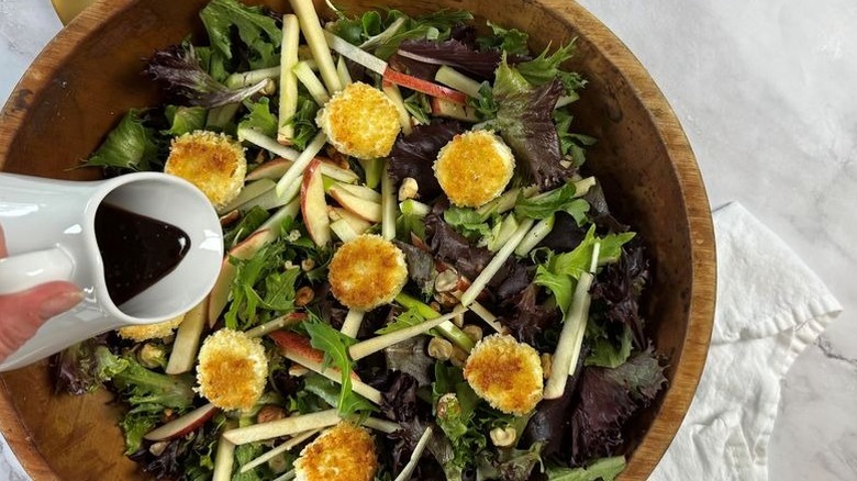 Dressing pouring out onto salad