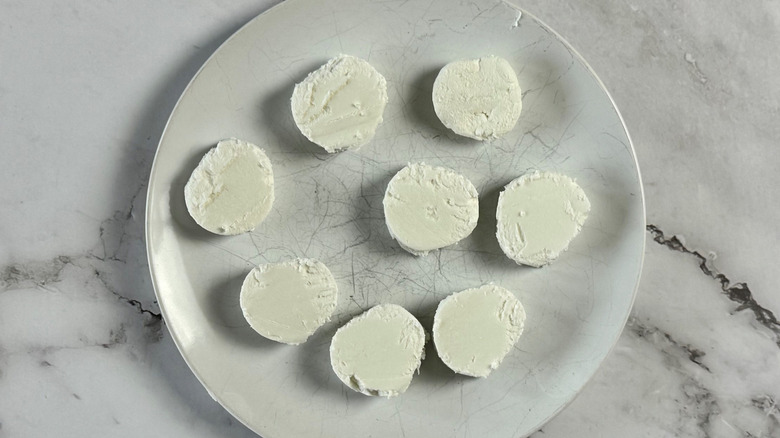 Goat cheese slices on plate