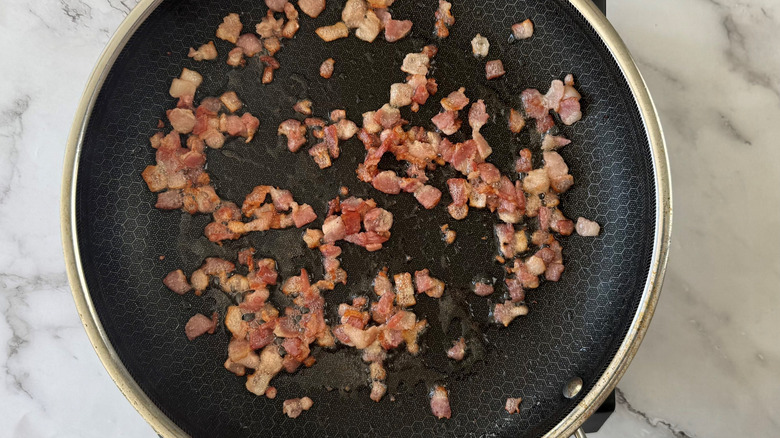Crispy chopped bacon in skillet