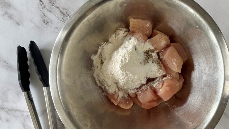 diced chicken with flour in bowl