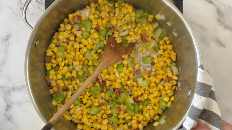 Corn, celery, onion, and bacon in soup pot