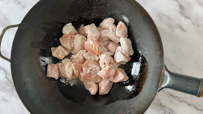 diced chicken in wok