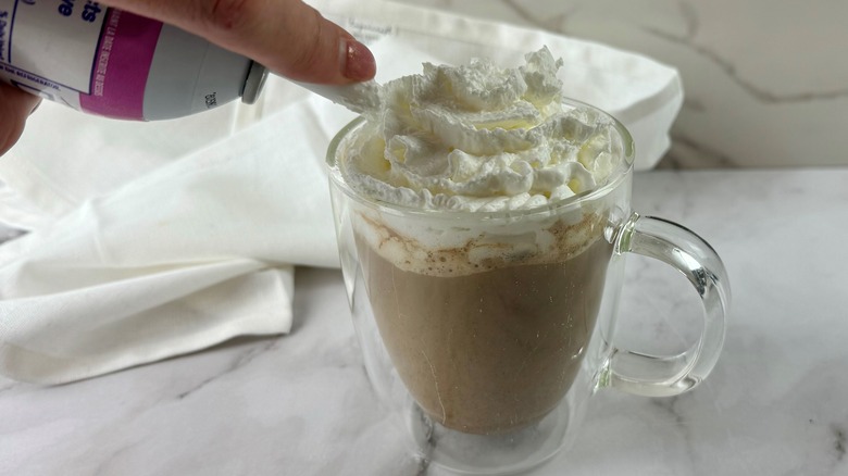 hand squirting aerosol whipped cream