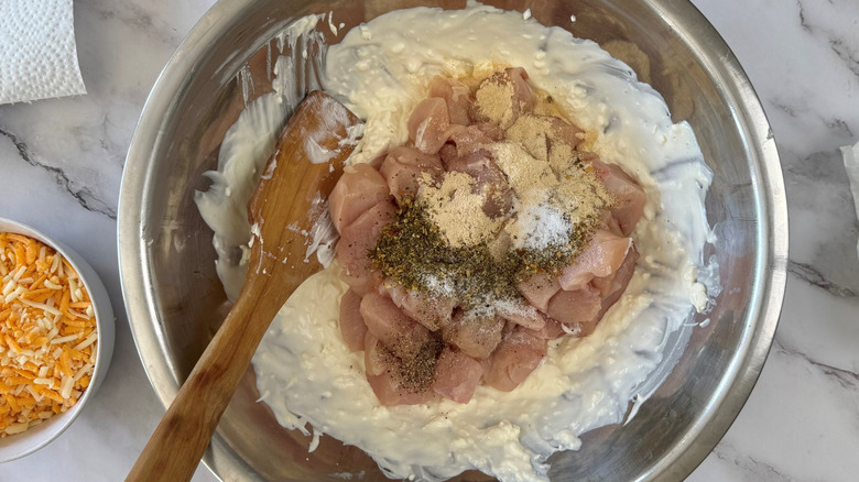 chicken and seasonings with cheesy mixture