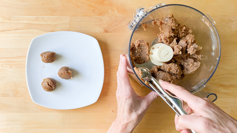 Scooping no-bake snickerdoodle cookie dough balls
