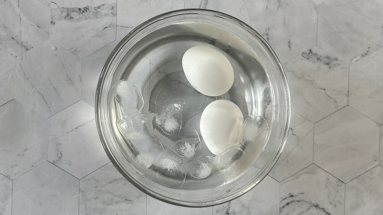 boiled eggs chilling in bowl with ice water