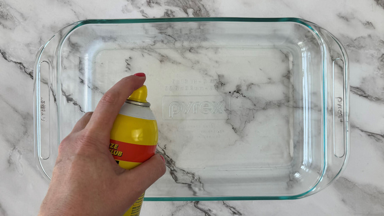 greasing baking dish with spray can