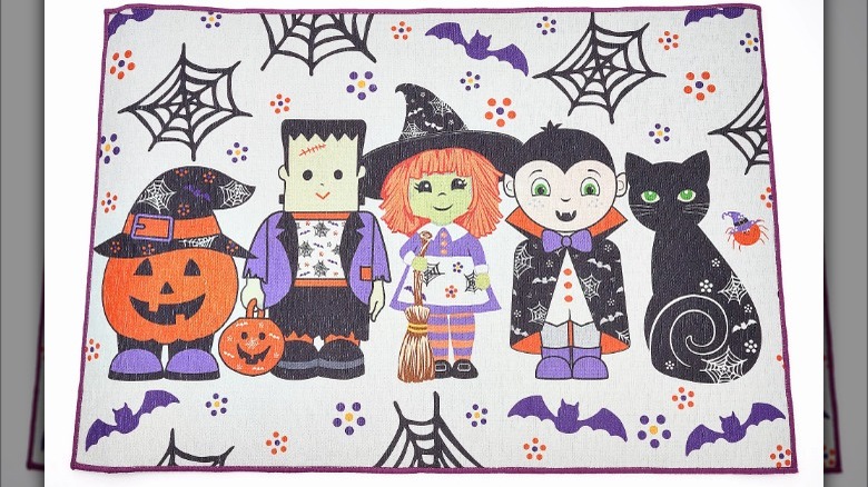 A Temp-tations seasonal mat with cartoon Halloween characters on it