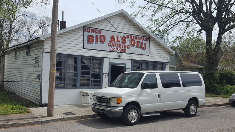 Big Al's Deli & Catering storefront with white van parked out front