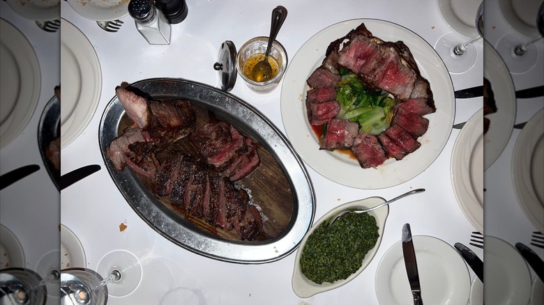 A plate of steak with a side of creamed spinach at Keens Steakhouse