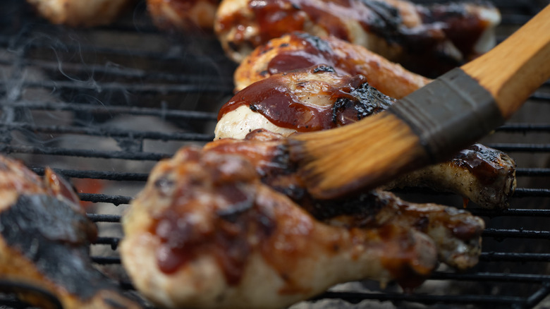 brushing bbq sauce on chicken